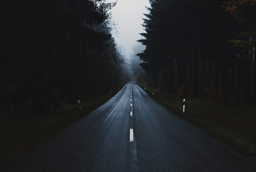 Road at dusk with car headlights